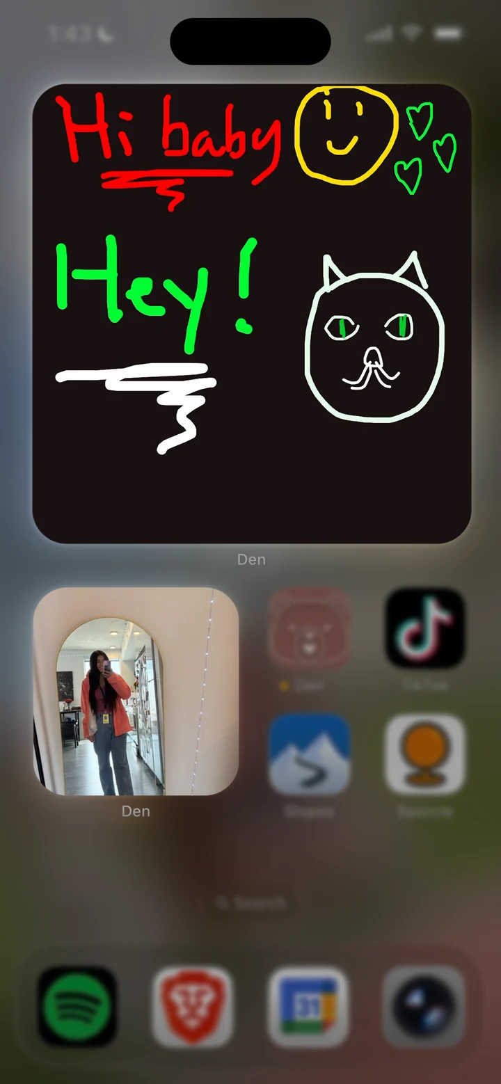 A hand-drawn doodle saying Hi baby and Hey in a large Den home screen widget, above a small partner selfie